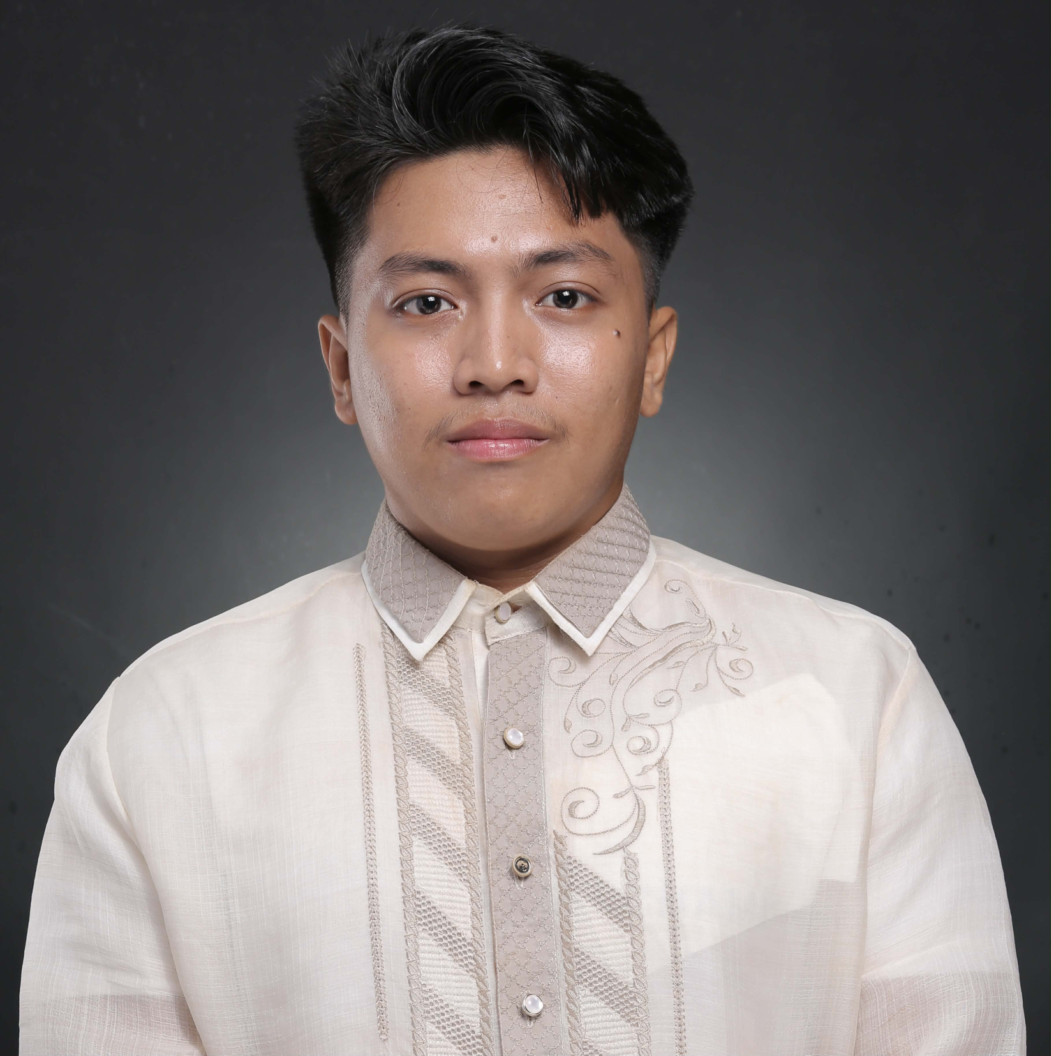 A professional formal portrait of the owner of Malabanan Visayas, wearing a meticulously detailed traditional Barong Filipino with modern geometric and floral embroidery.